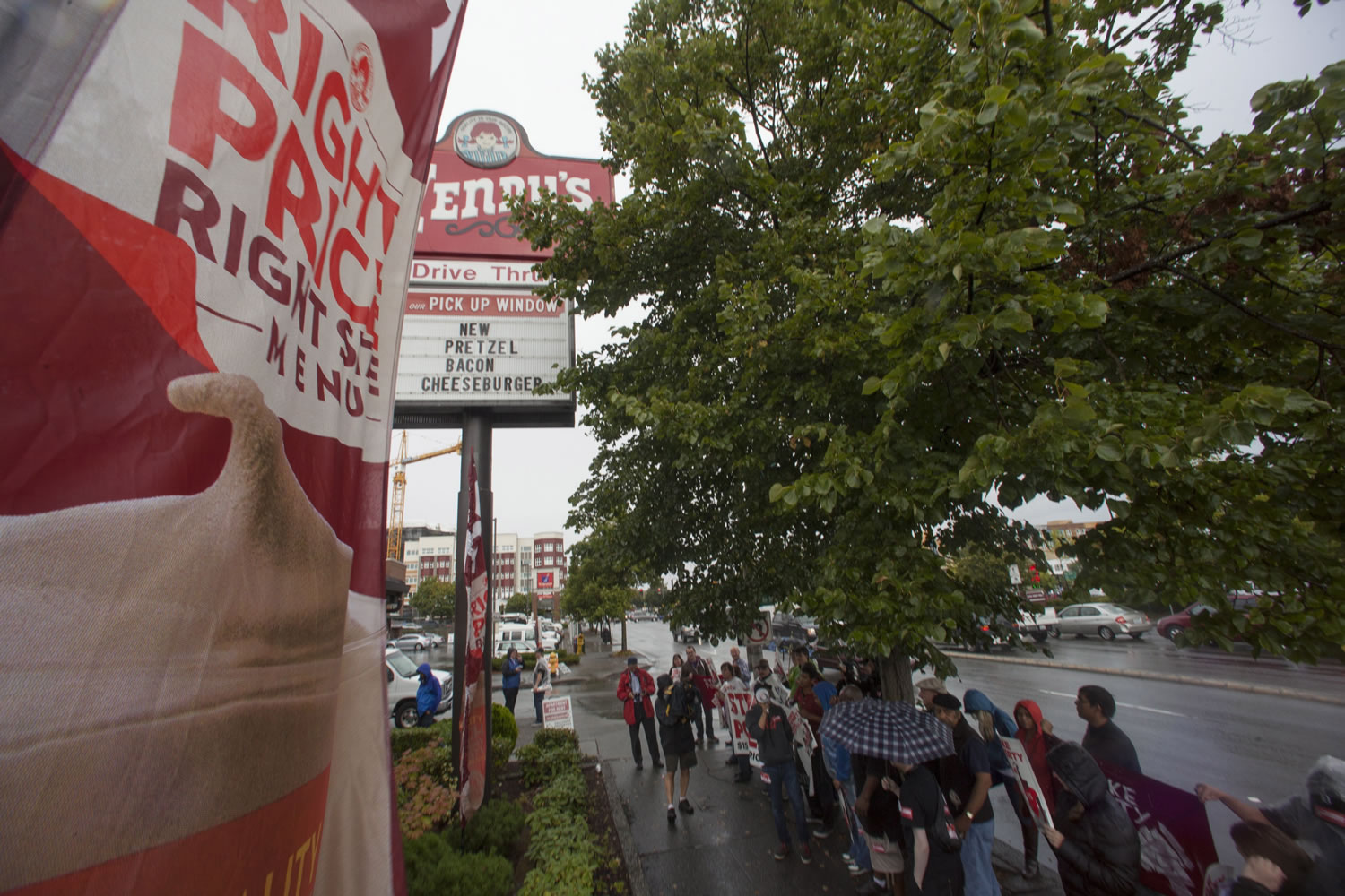 Fast-food workers and others protest Thursday at the Wendy's in Seattle's Ballard neighborhood, calling for the minimum wage to be raised to $15 an hour.