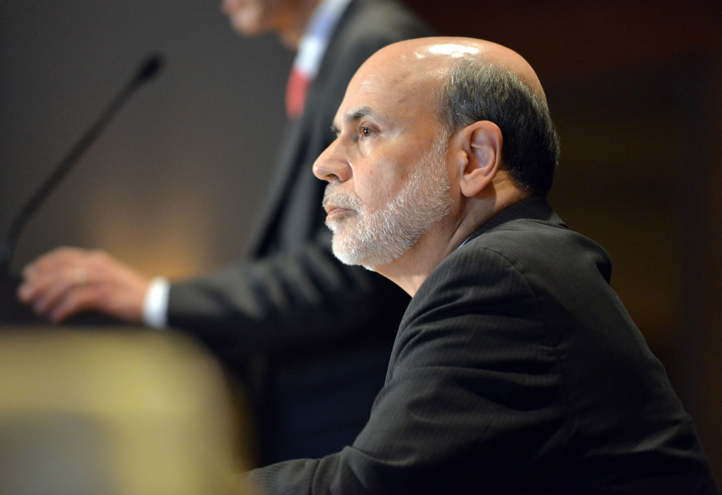 Federal Reserve Board Chairman Ben Bernanke listens to during his introduction at the National Bureau of Economic Research Wednesday, July 10, 2013, in Cambridge, Mass. Bernanke spoke after the markets closed with stocks fluctuating between small gains and losses Wednesday morning, before the Federal Reserve released minutes from its most recent meeting.