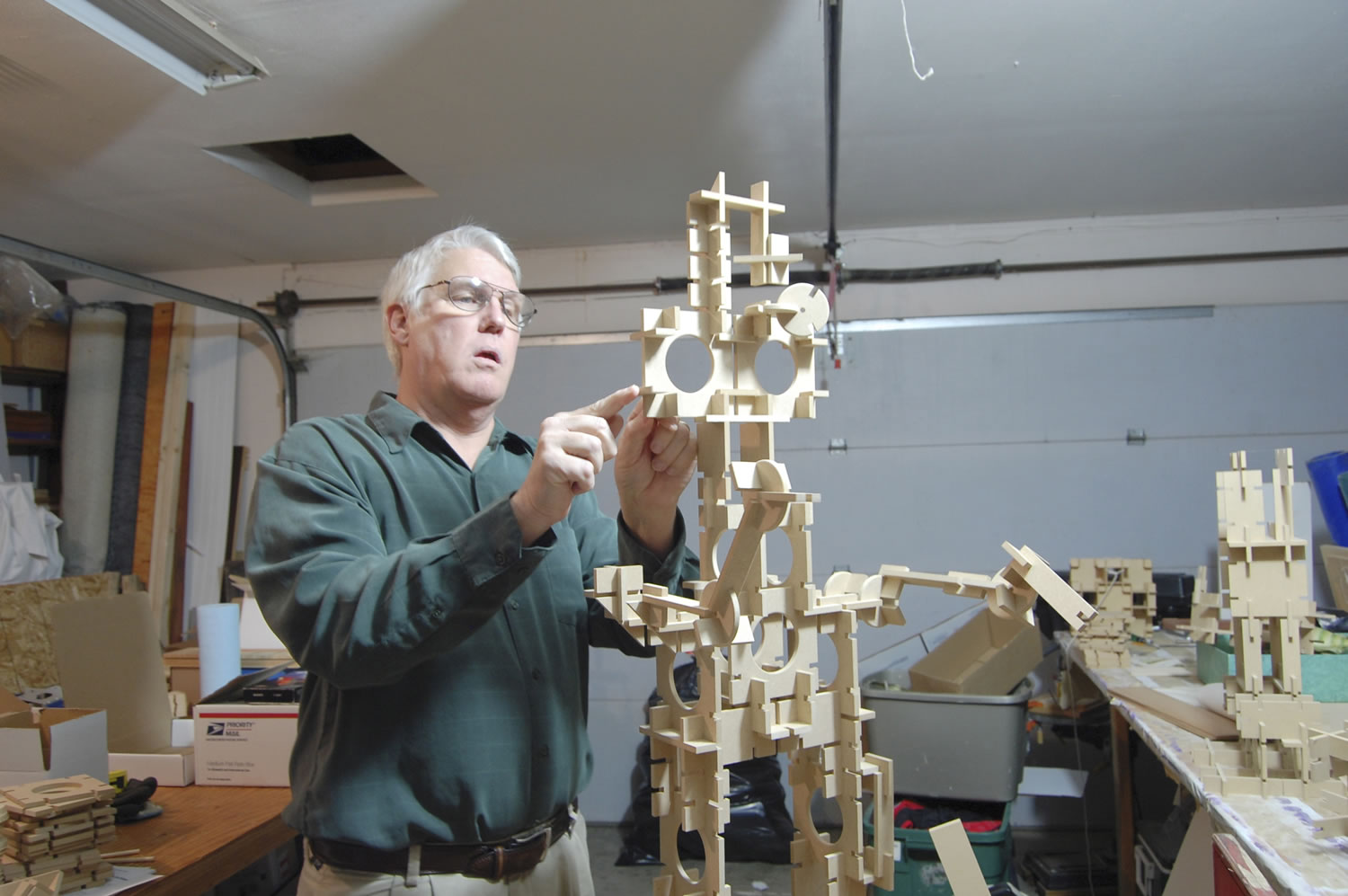 Robert Darling assembles a robot from one of his Slotto sets in his home workshop in January 2010.