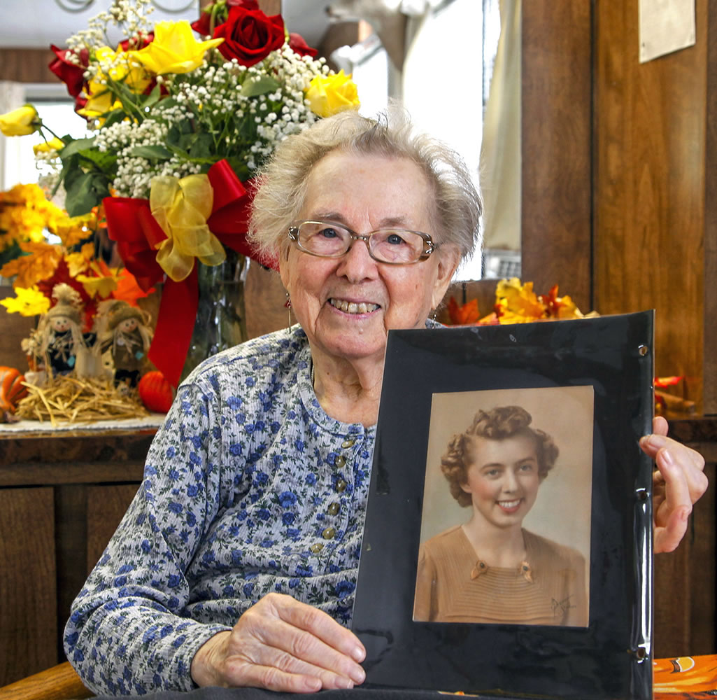Ruby Hazen of Silver Lake holds her portrait, filched 70 years ago by a young Coast Guard member.