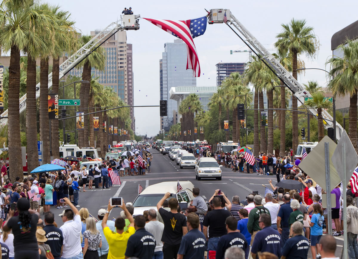 A procession of 19 hearses drives Sunday through Phoenix. The 19 Hotshot firefighters were carried in procession in separate hearses from Phoenix to Prescott, Ariz.