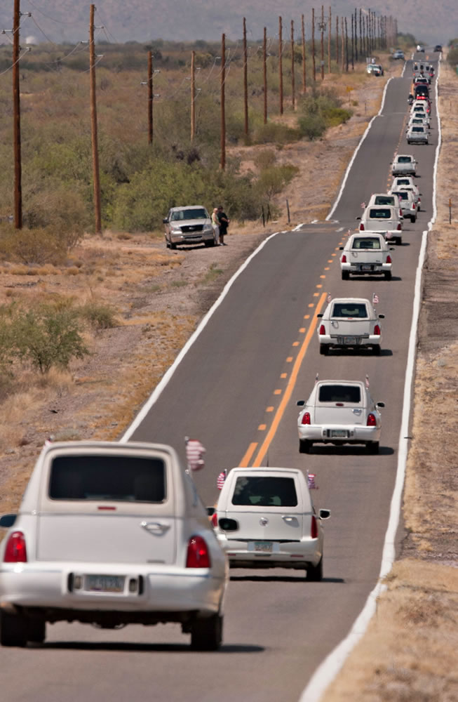 Tom Story/The Arizona Republic
A line of hearses makes their way north Sunday on Highway 89, south of Congress, Ariz., as the bodies of the 19 members of the Granite Mountain Hotshots were returned to Prescott, Ariz. from Phoenix.