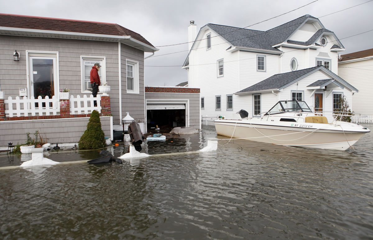 A boat float in the driveway of a home on Long Island in the flooding aftermath of Superstorm Sandy in 2012, in Lindenhurst, N.Y.
