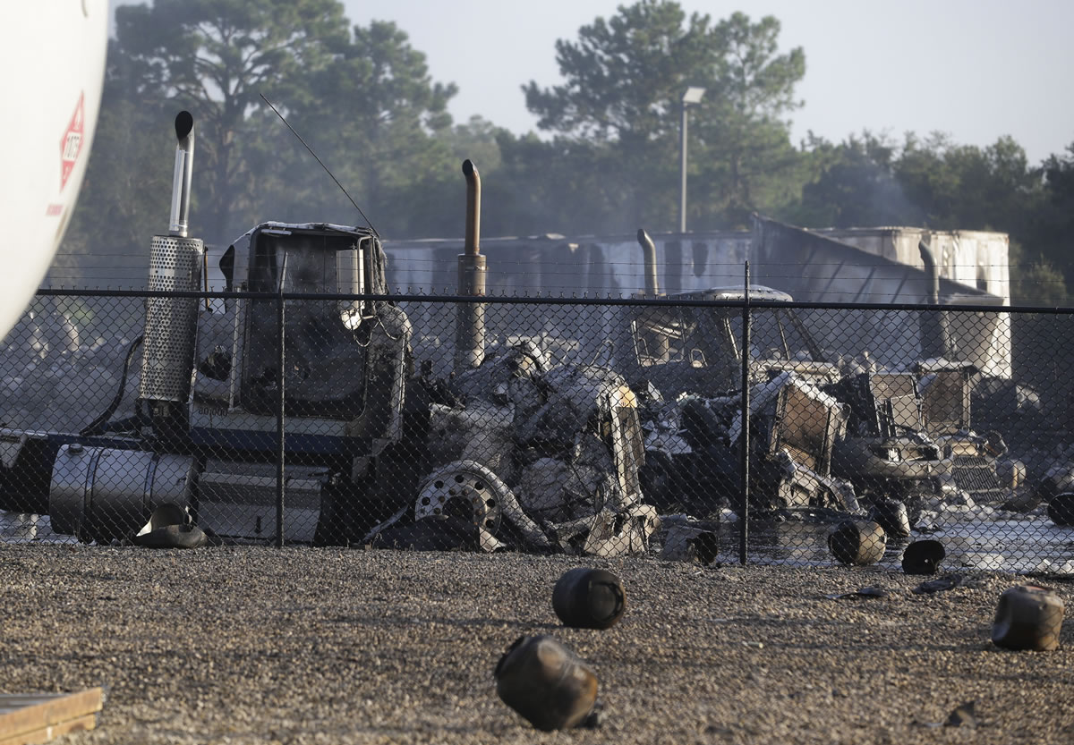 The remains of several burned and melted trucks are seen after an explosion at a propane gas company Tuesday  in Tavares, Fla.