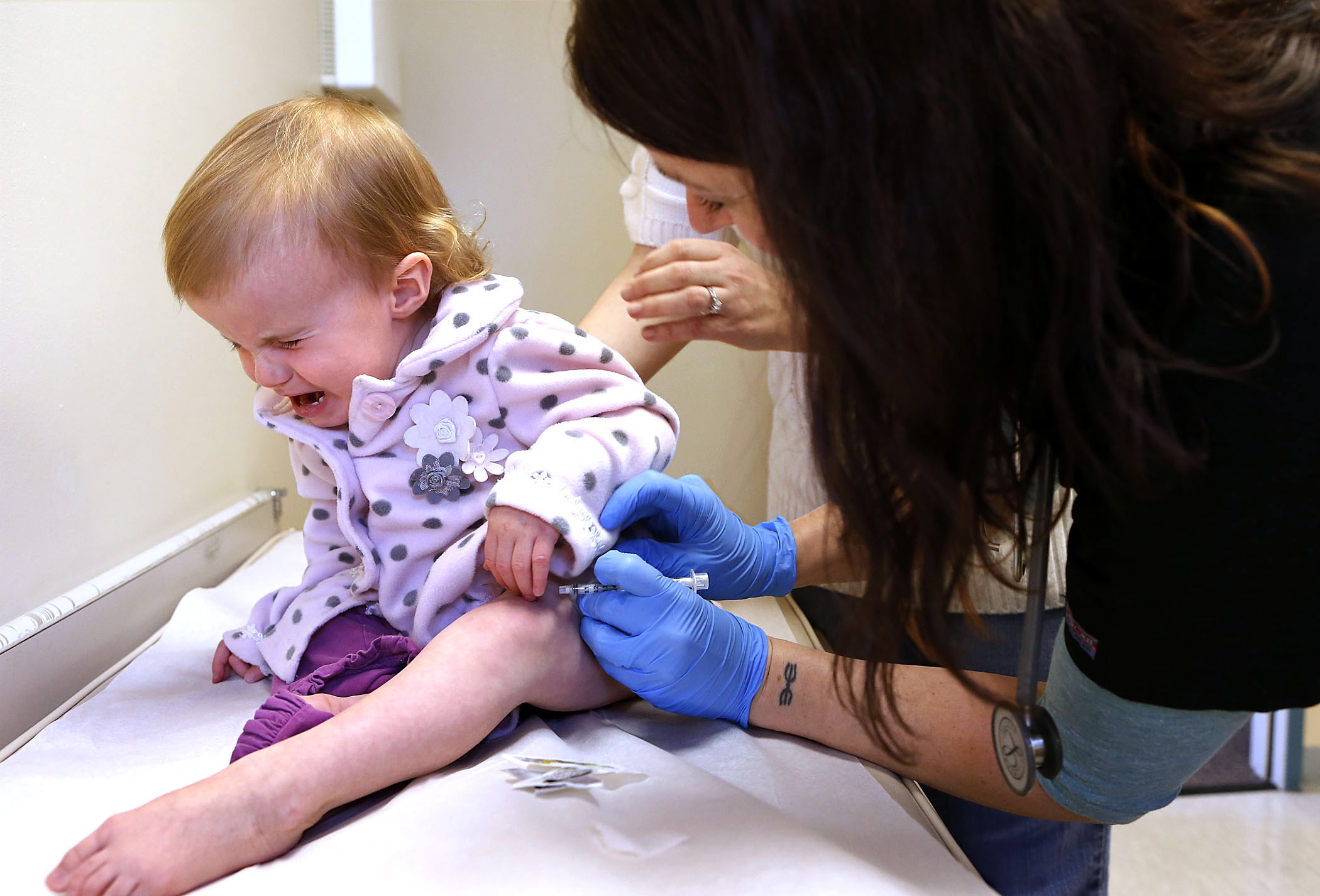 PAUL CARTER/The (Eugene) Register Guard
Sophia Stricker, 17 months, endures a flu shot from nurse Katy Whitman on Friday in Eugene, Ore. Clark County Health Officer Dr. Alan Melnick says it's still not too late to get a flu vaccine.