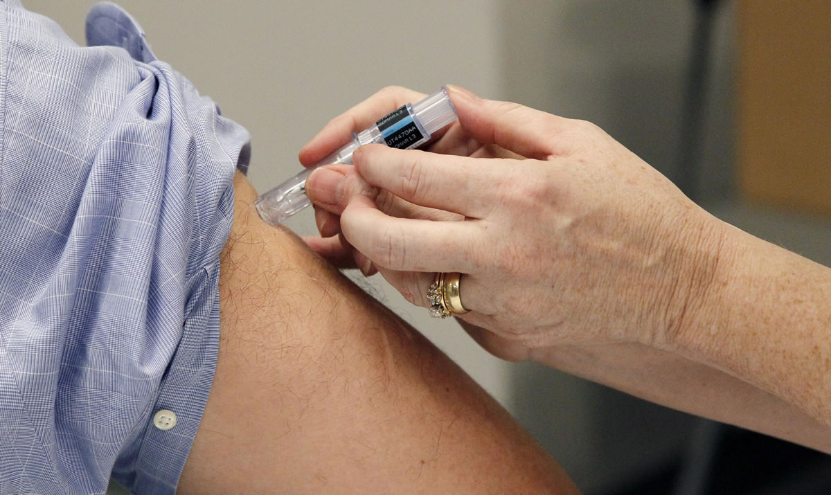 A flu shot is administered in Jackson, Miss.