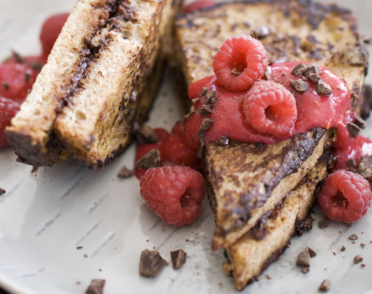 Chocolate-stuffed French toast with raspberry sauce is a nutritious and delicious dish for breakfast in bed.