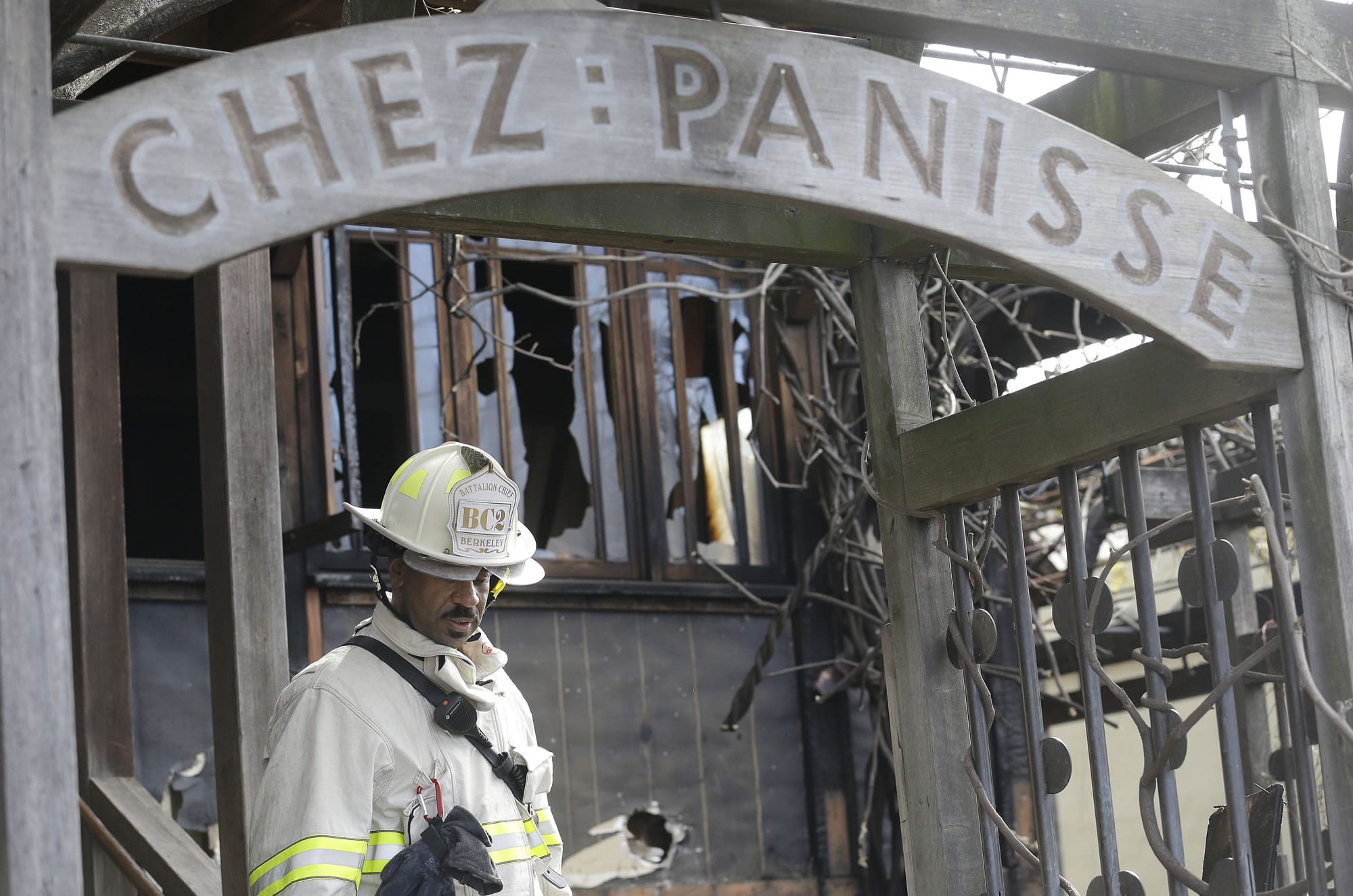 FILE - In this March 8, 2013 file photo, Acting Berkeley Fire Department Deputy Chief Avery Webb inspects damage at Chez Panisse restaurant in Berkeley, Calif. After a fire in March shut the doors to the famous gourmet restaurant, the eatery is preparing to reopen on June 24.