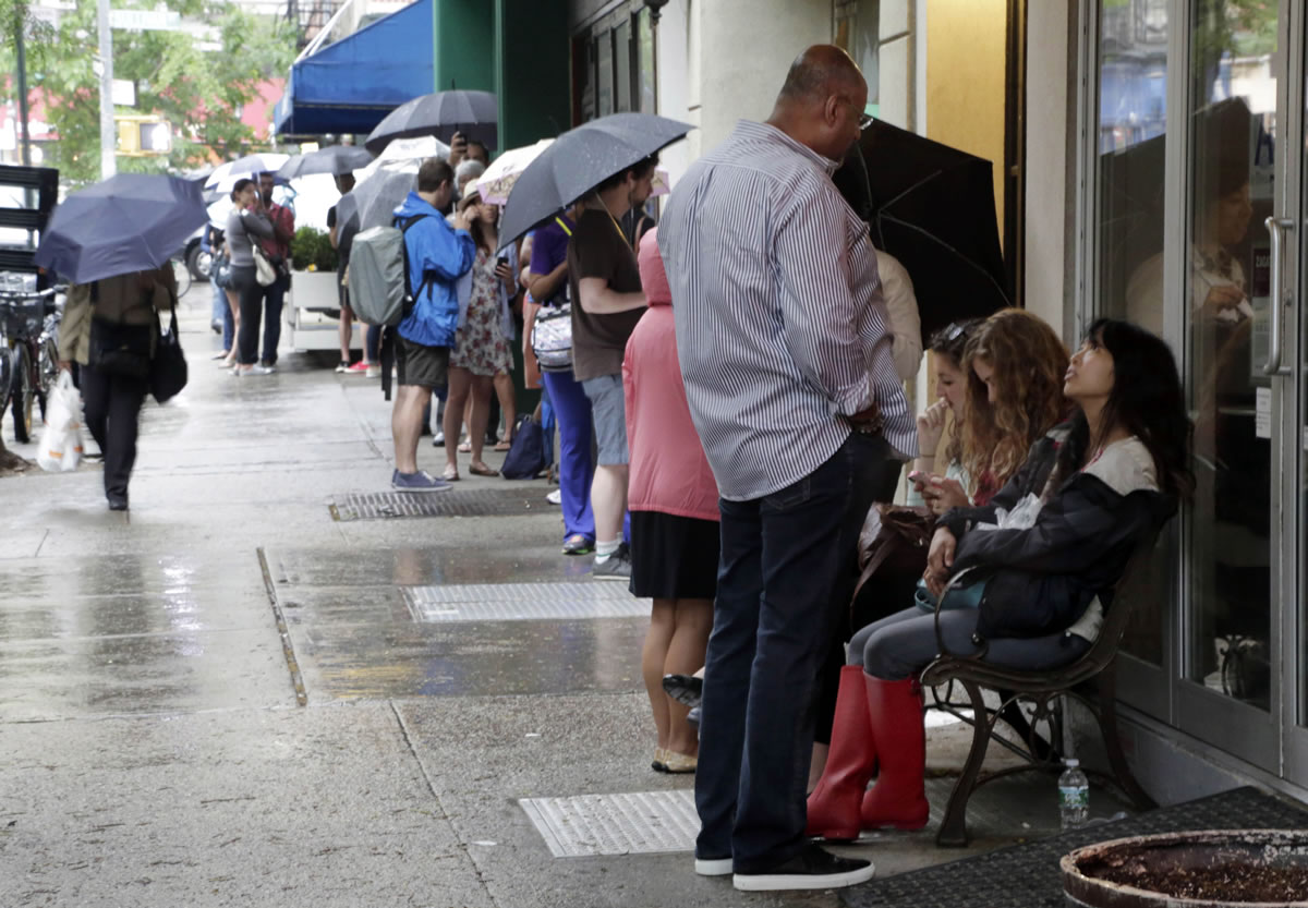 This June 3 photo shows customers lining up outside New York's Dominique Ansel Bakery to purchase Cronuts, a croissant-donut hybrid, in New York.
