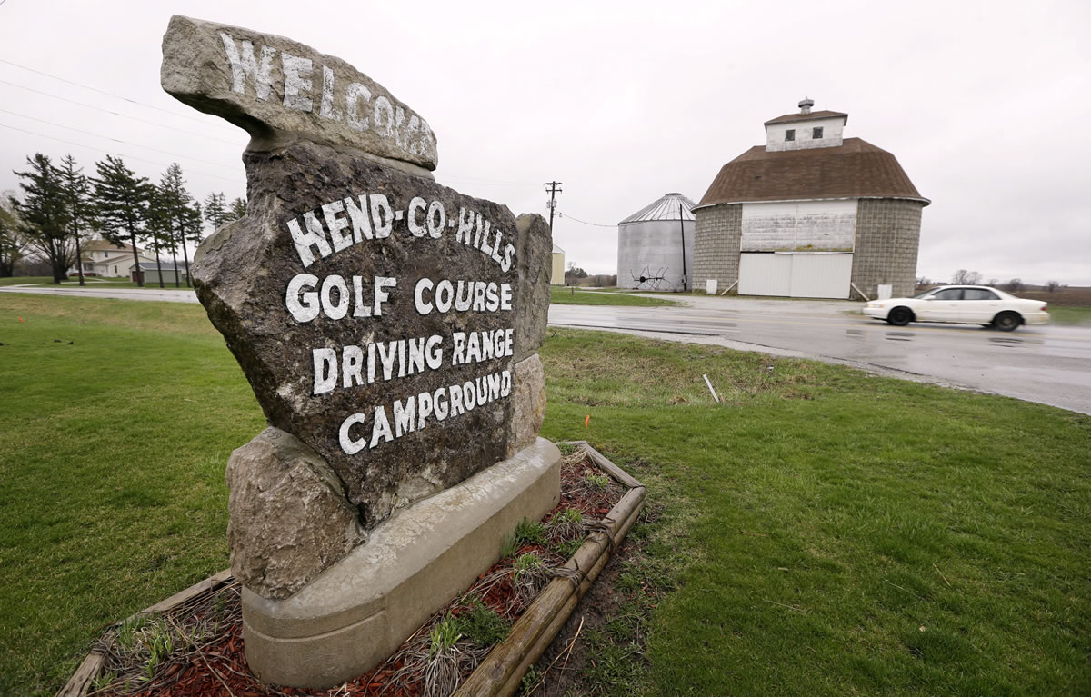 A sign for the Hend-Co-Hills Golf Course sits near a storage barn on a farm in Biggsville, Ill.