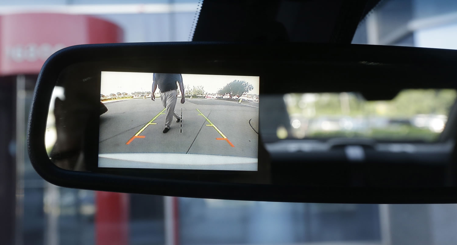 A new surveillance system that displays on the rear view mirror in police cars automatically sounds a chime, locks the doors and rolls up the windows if it detects someone approaching the car from behind.