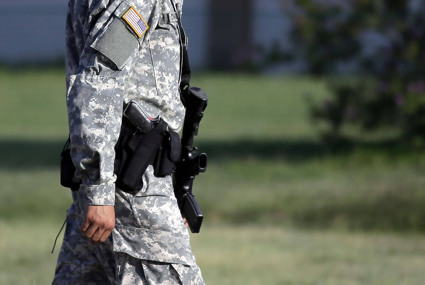 A U.S. Army military police officer patrols in front of the Lawrence H. Williams Judicial Center as proceedings in the court martial of U.S. Army Maj.