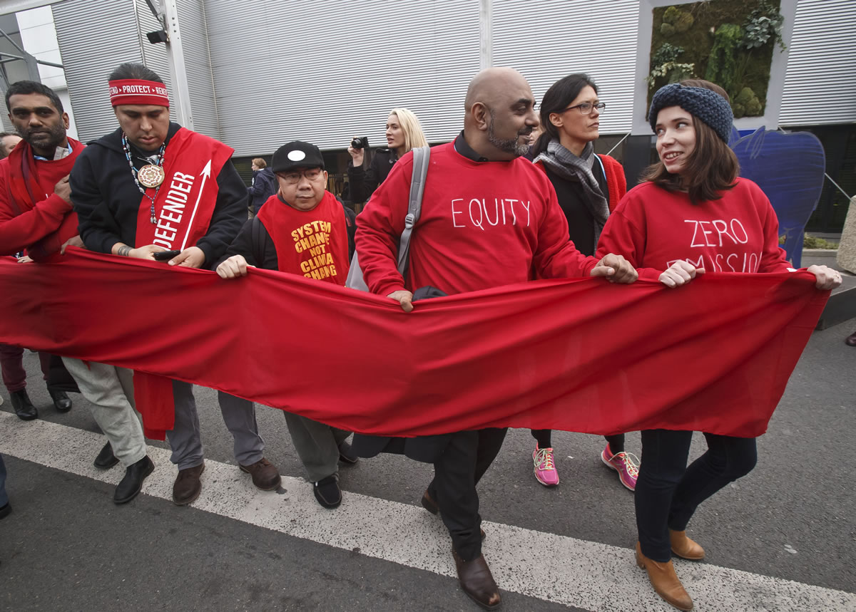 Climate activists carry a red banner Friday during a demonstration at the COP21, United Nations Climate Change Conference, in Le Bourget, north of Paris. Hundreds of climate activists have stretched a block-long red banner through the Paris climate talks to symbolize &quot;the red lines&quot; that they don&#039;t want negotiators to cross in trying to reach an international accord to fight global warming.