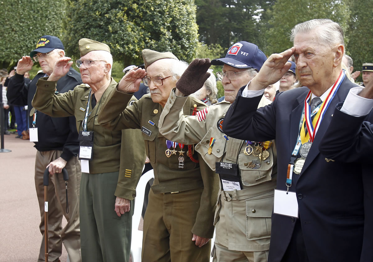 U.S. World War II veterans salute during the national anthems at a ceremony at the Memorial of the Colleville American military cemetery in Colleville-sur-Mer, France, on Thursday, the 69th anniversary of the D-Day invasion. From left: Melbert Hillert, 91, of Frisco, Texas; Earl Tweed, 91, of Dallas; Robert Blatnik, 93, of Raleigh, Texas; Robert Bearden, 90, of Belton, Texas; and Joseph J. Turecky, 91, of Dallas.