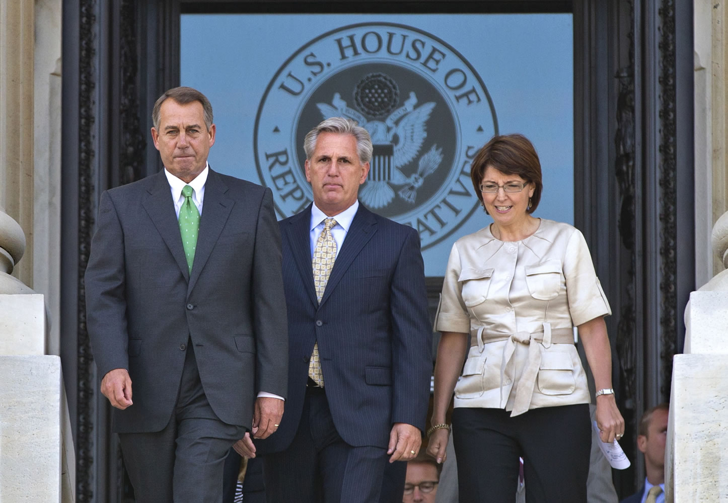 House Speaker John Boehner, left, R-Ohio; House Majority Whip Kevin McCarthy, R-Calif.; and Rep. Cathy McMorris Rodgers, R-Wash., the Republican Conference chairwoman, exit the House side of the U.S.
