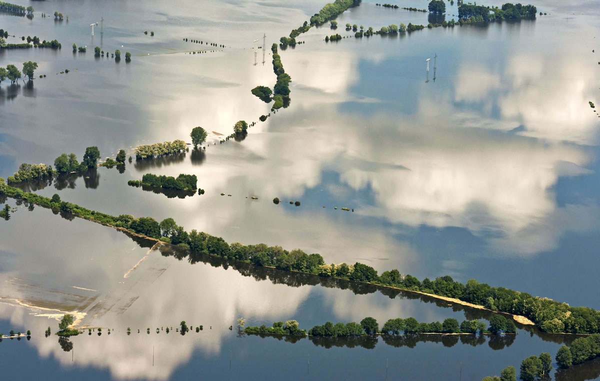 Clouds reflect in the floods by the river Elbe near Tangermuende, central Germany, on Tuesday.