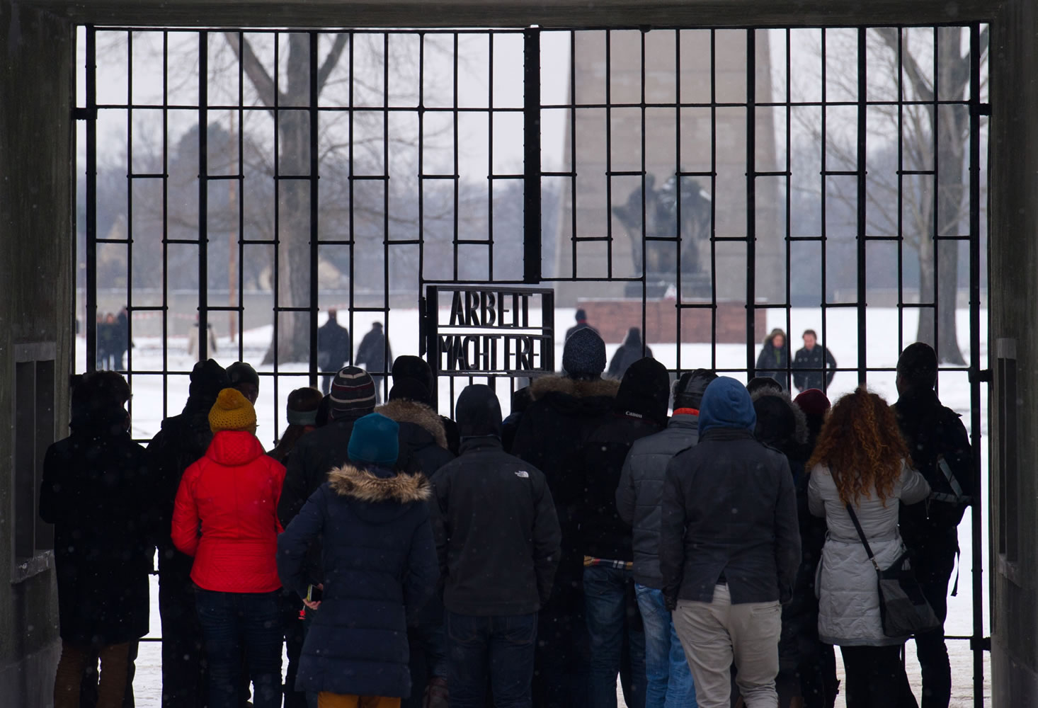 Visitors stand Sunday in front of the gate of the former nazi concentration camp Sachsenhausen in Oranienburg, eastern Germany.