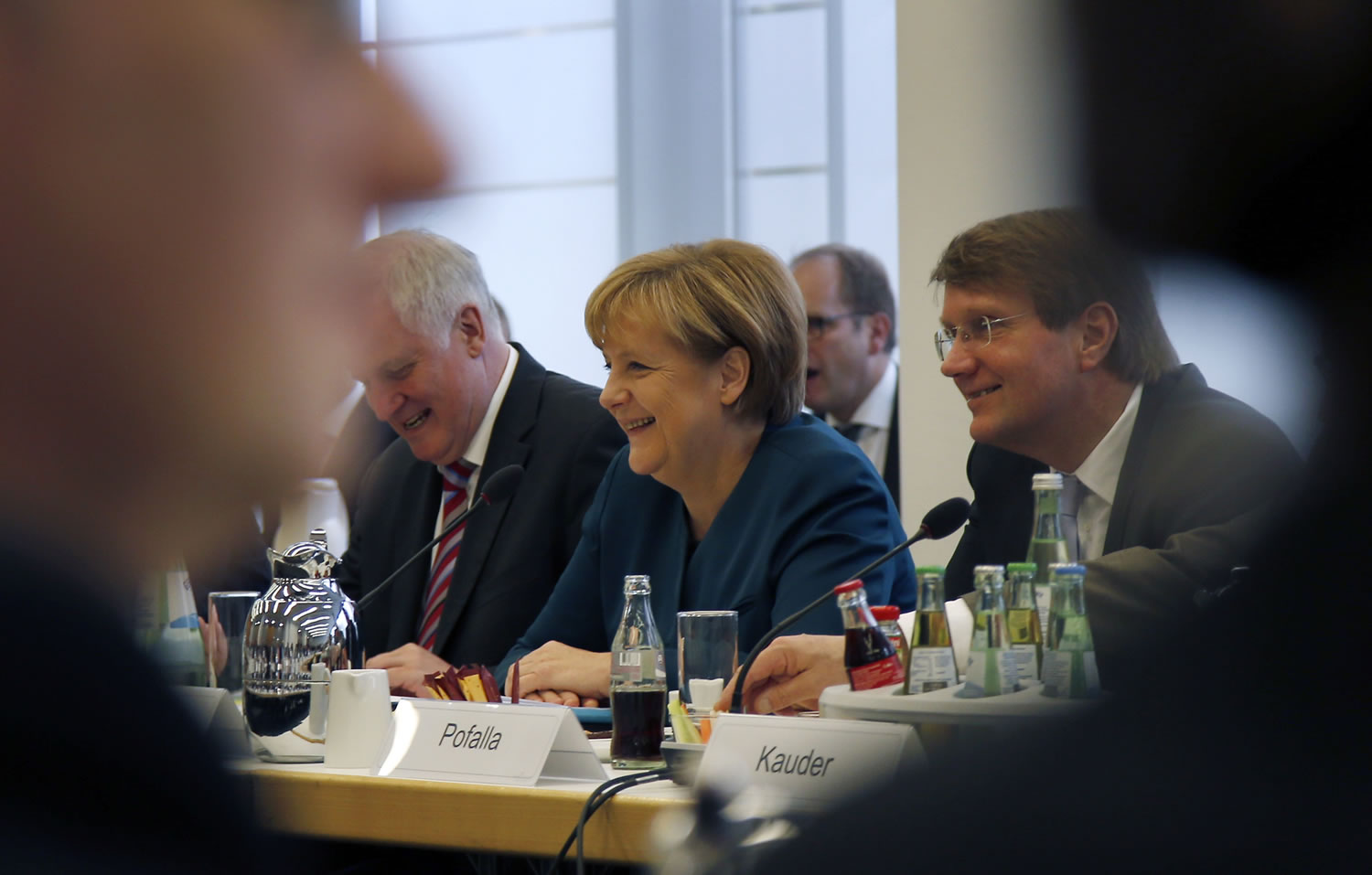 German Chancellor Angela Merkel, center, opens coalition talks with representatives of the Social Democrats in Berlin, Germany, on Wednesday.
