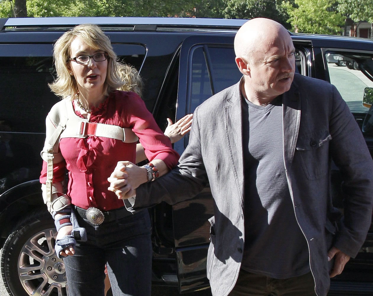 Former Arizona Rep. Gabrielle Giffords and her husband, retired astronaut and combat veteran Capt. Mark Kelly, arrive to meet with local supporters and parents of Sandy Hook Elementary School victims Friday at the Orchard Street Chop Shop in Dover, N.H.