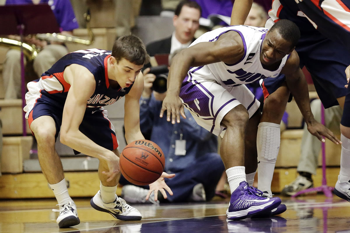 Gonzaga guard David Stockton, left, steals the ball from Portland guard Derrick Rodgers during the first half of an NCAA college basketball game in Portland, Ore., Thursday, Jan. 17, 2013.