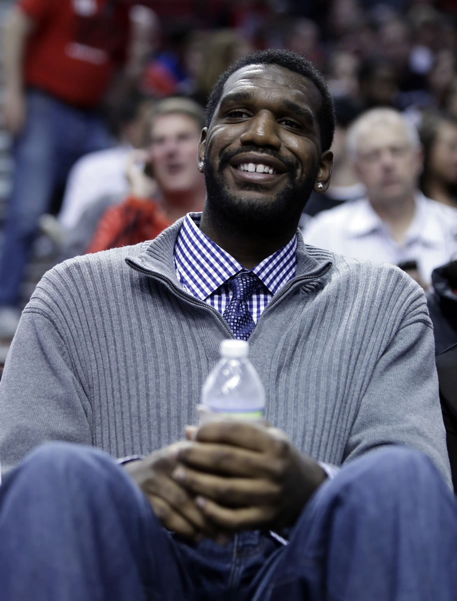 Former Blazers center Greg Oden watches from the front row at the Rose Garden as Portland faces the Memphis Grizzlies and Oden's childhood friend Mike Conley.