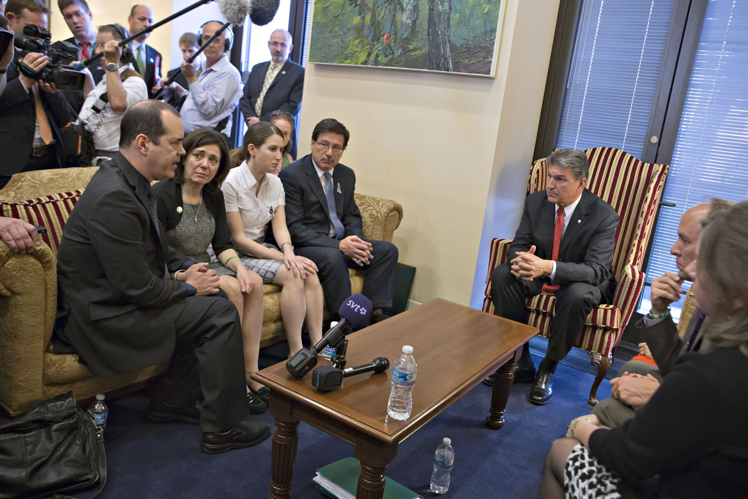 Sen. Joe Manchin, D-W.Va., seated right, meets in his office with families of victims of the  Sandy Hook Elementary School shooting in Newtown, Conn., on the day he announced that they have reached a bipartisan deal on expanding background checks to more gun buyers on Capitol Hill in Washington on Wednesday. Seated on sofa from left are David and Francine Wheeler, who lost their 6-year-old son Ben in the shooting, Katy Sherlach and her father Bill Sherlach, whose wife Mary Sherlach was killed.