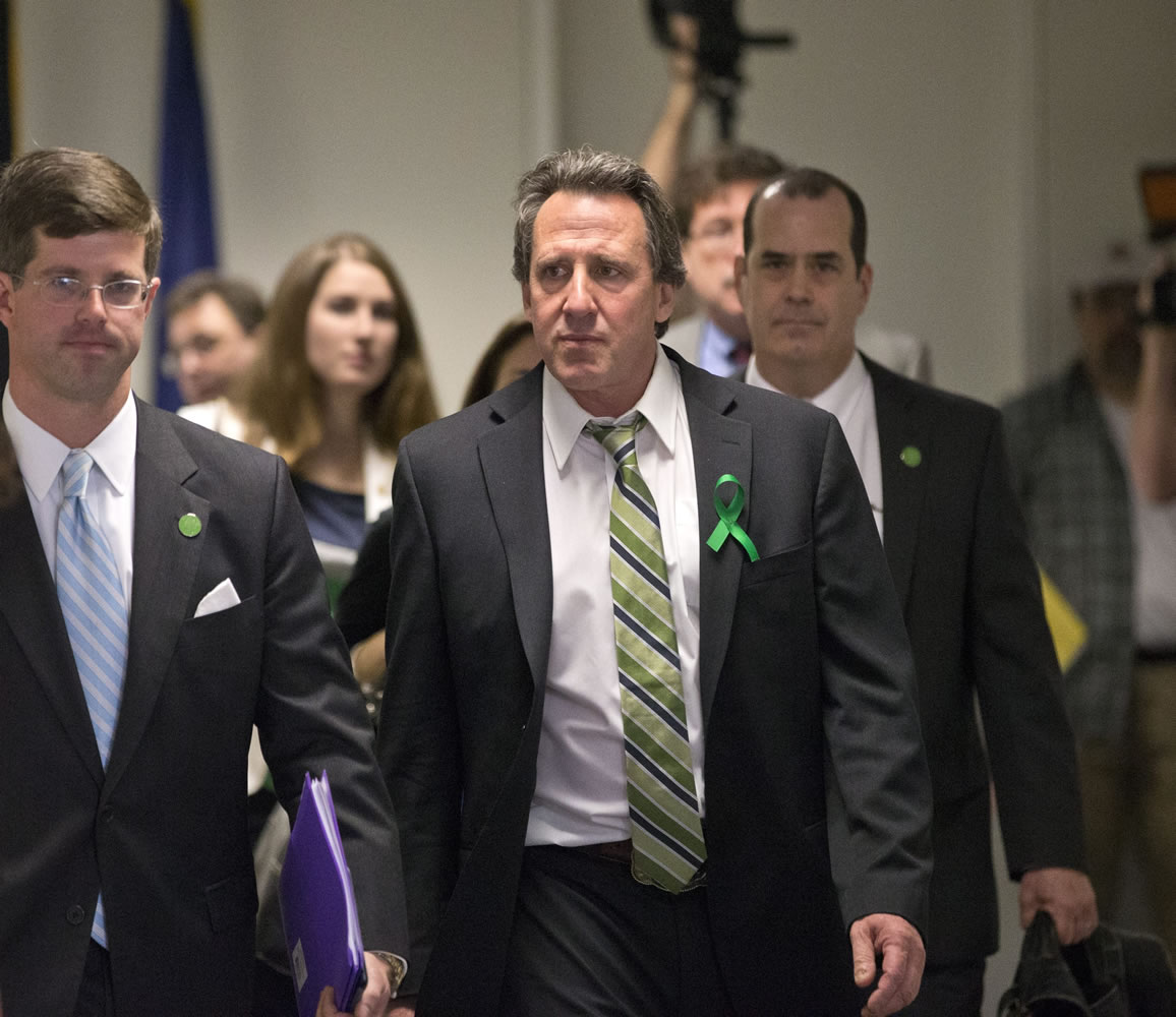 Neil Heslin, center, whose 6-year-old son Jesse was killed in the mass shooting in Newtown, Conn., arrives with other victims' families to meet privately on Capitol Hill in Washington on Tuesday with Sen. Richard Blumenthal, D-Conn., and Sen. Chris Murphy, D-Conn.