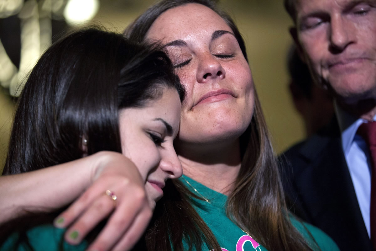 Carlee Soto, sister of Sandy Hook teacher Victoria Soto, left, and Erica Laffferty, daughter of Sandy Hook principal Dawn Hochsprung, embrace outside the Senate chamber after a vote on gun legislation on Capitol Hill on Wednesday in Washington.