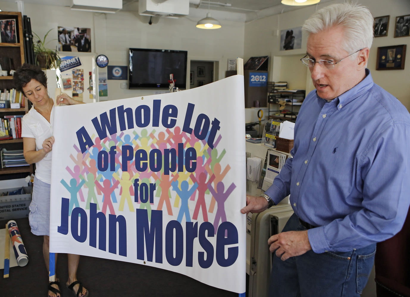 Democratic state Senate President John Morse, right, and Cristy Le Lait roll out a banner at the Democratic Party offices in Colorado Springs, Colo., that they plan to use to urge voters not to sign petitions for Morse's recall.