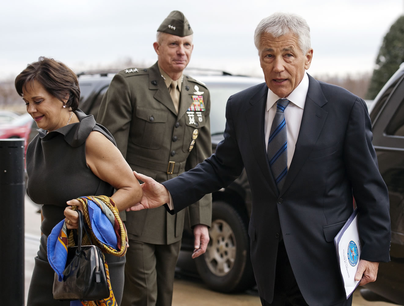 Marine Corp. Lt. Gen. Tom Waldheuser, center, greets Sen. Chuck Hagel, R-Neb., right, and his wife, Lilibet, as they arrive at the Pentagon to be sworn-in as Secretary of Defense in Arlington, Va., on Wednesday.