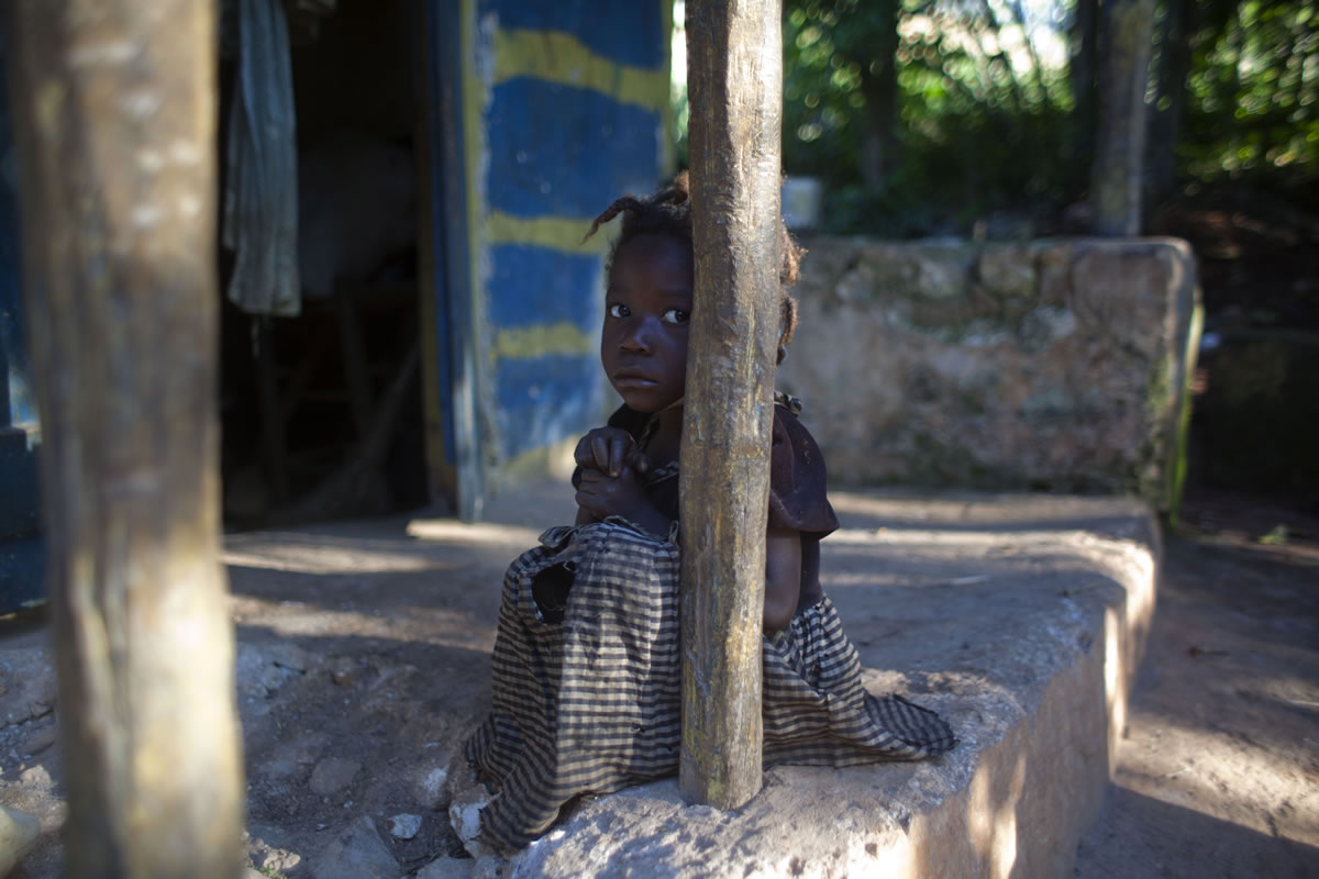 A malnourished 4-year-old Michelene Thelusme sits outside her home in Belle Anse, Haiti. In a country where half the food is imported, meals are becoming less affordable as the value of Haiti's currency depreciates against the U.S.
