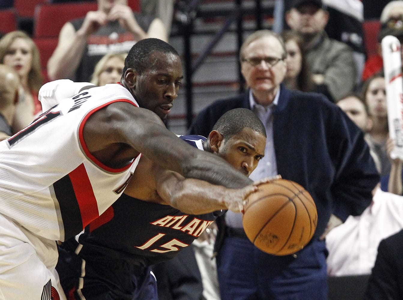 Portland Trail Blazers center J.J. Hickson, left, and Atlanta Hawks forward Al Horford battle for the ball during the second half Monday.