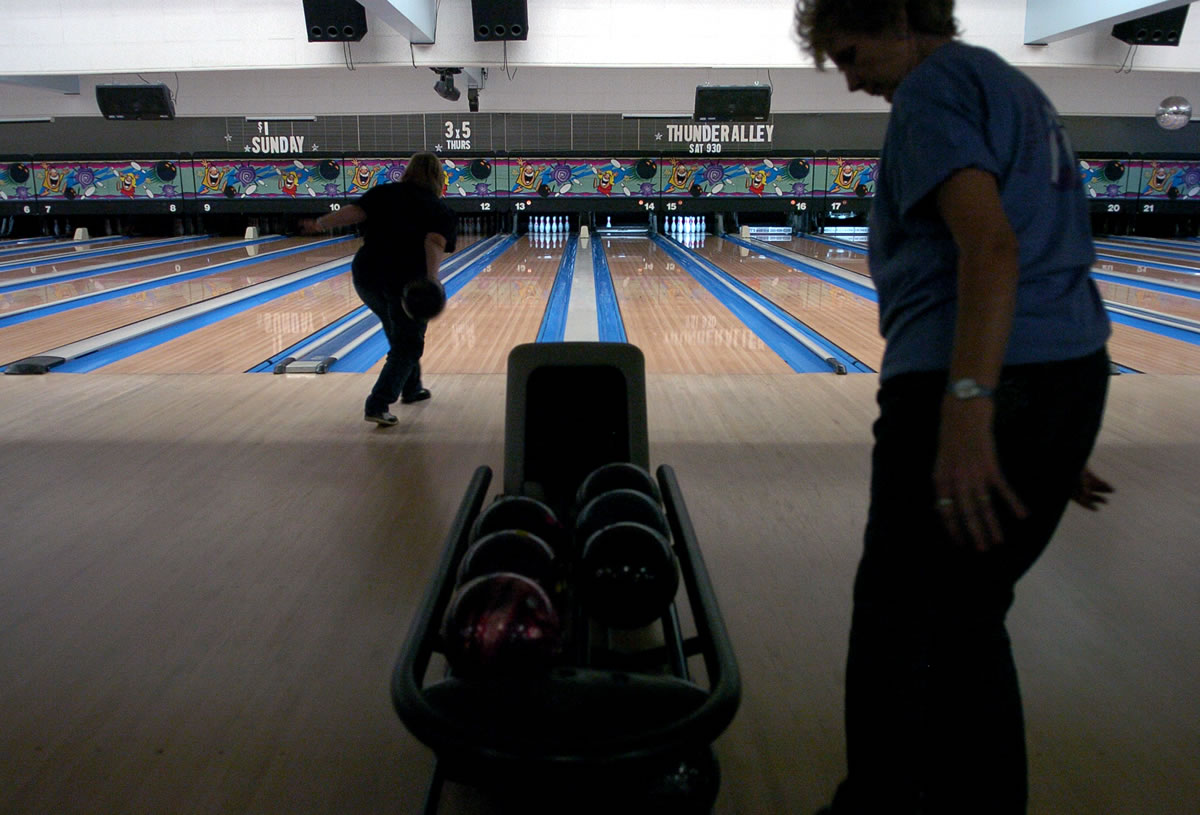 Twilla Brosseau, foreground, gets ready to bowl another frame during the 36th annual county mixed bowling tournament at Hazel Dell Lanes in Vancouver.