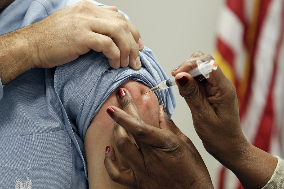 A patient gets a flu shot in 2012 in Jackson, Miss. Flu vaccination is no longer merely a choice between a jab in the arm or a squirt in the nose. This fall, some brands promise a little extra protection.
