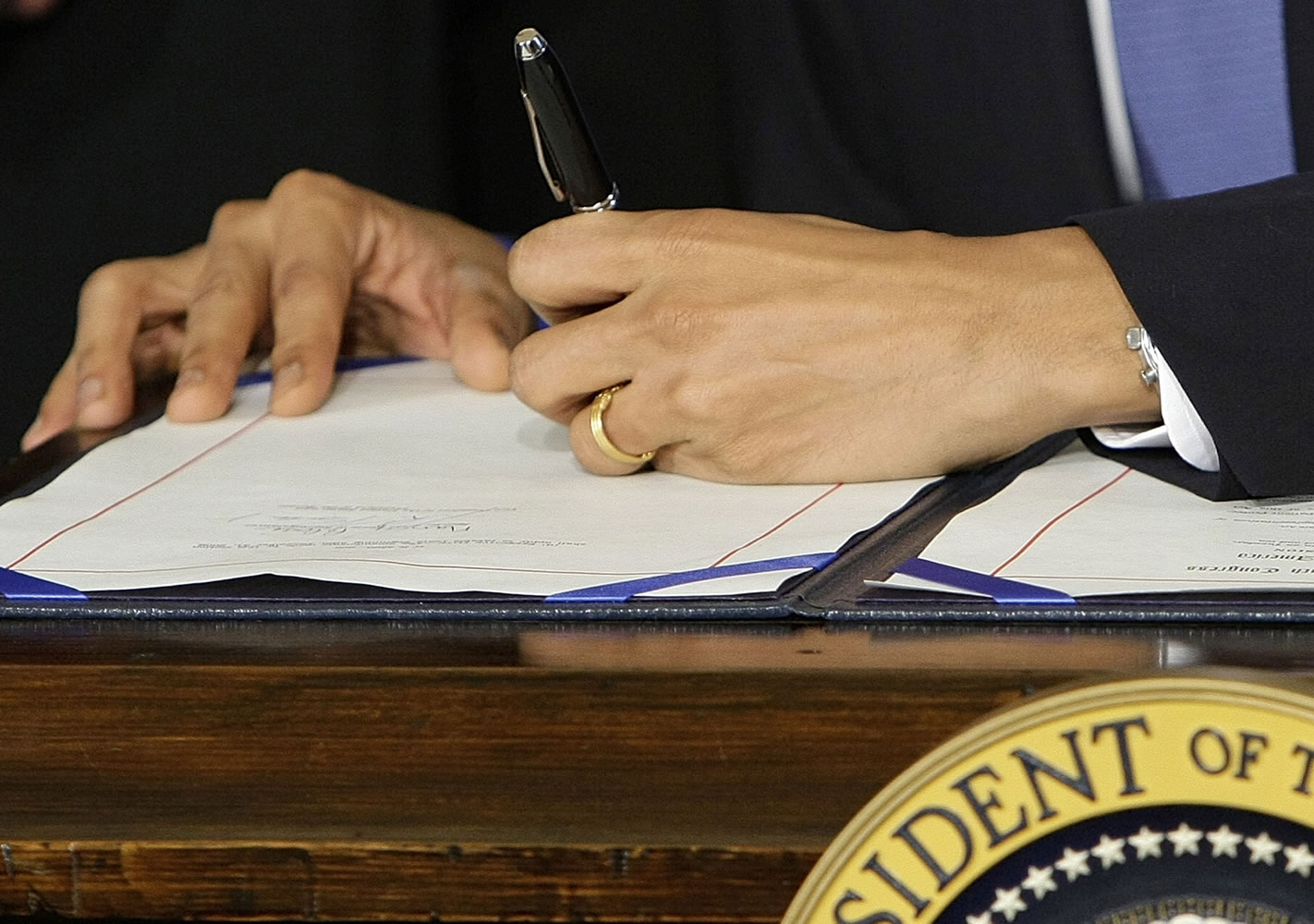 President Barack Obama signs the health care bill in the East Room of the White House in Washington in 2010.