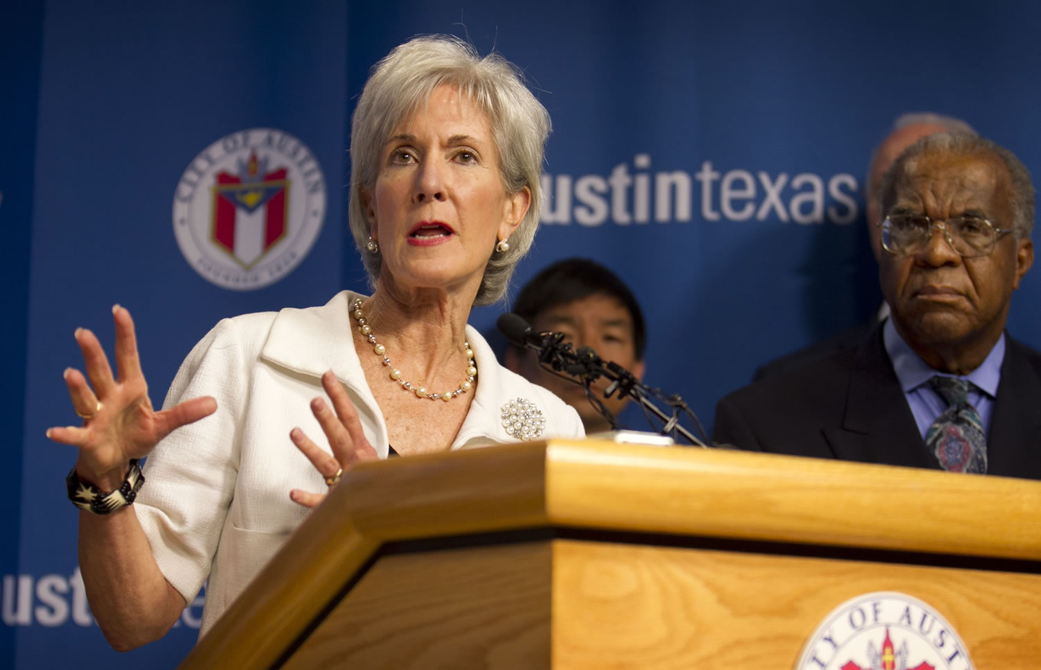 Secretary of Health and Human Services Kathleen Sebelius, left, speaks at a news conference at City Hall in Austin, Texas, on Thursday.