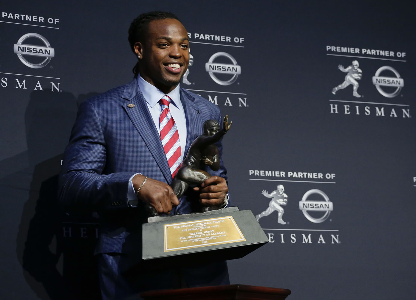Alabama's Derrick Henry poses for photos after winning the Heisman Trophy, Saturday, Dec. 12, 2015, in New York.