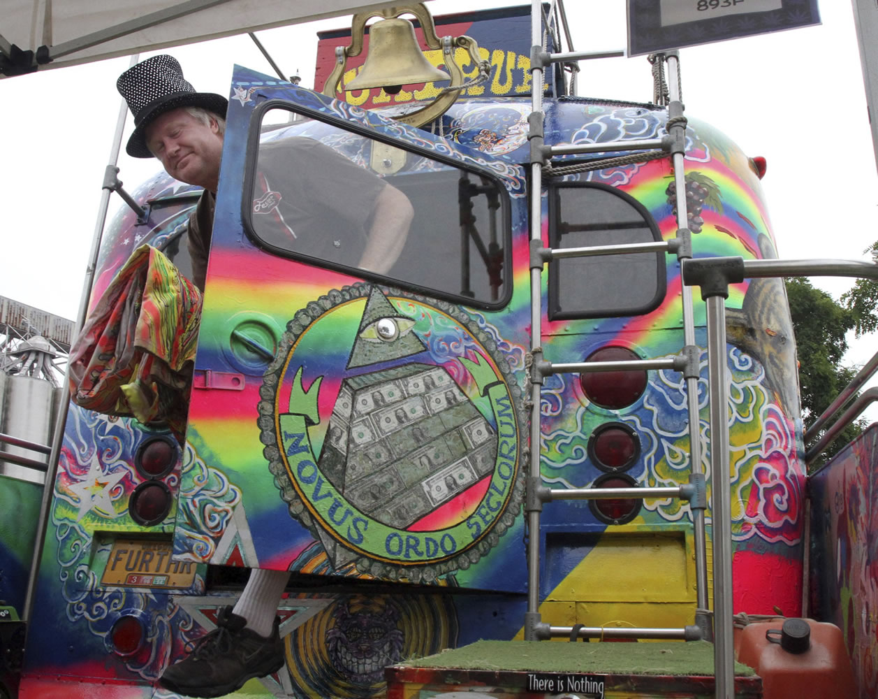 Zane Kesey of Eugene, Ore., emerges from the famous Merry Prankster bus that belonged to his late father, Ken Kesey, Saturday at Seattle's annual Hempfest.