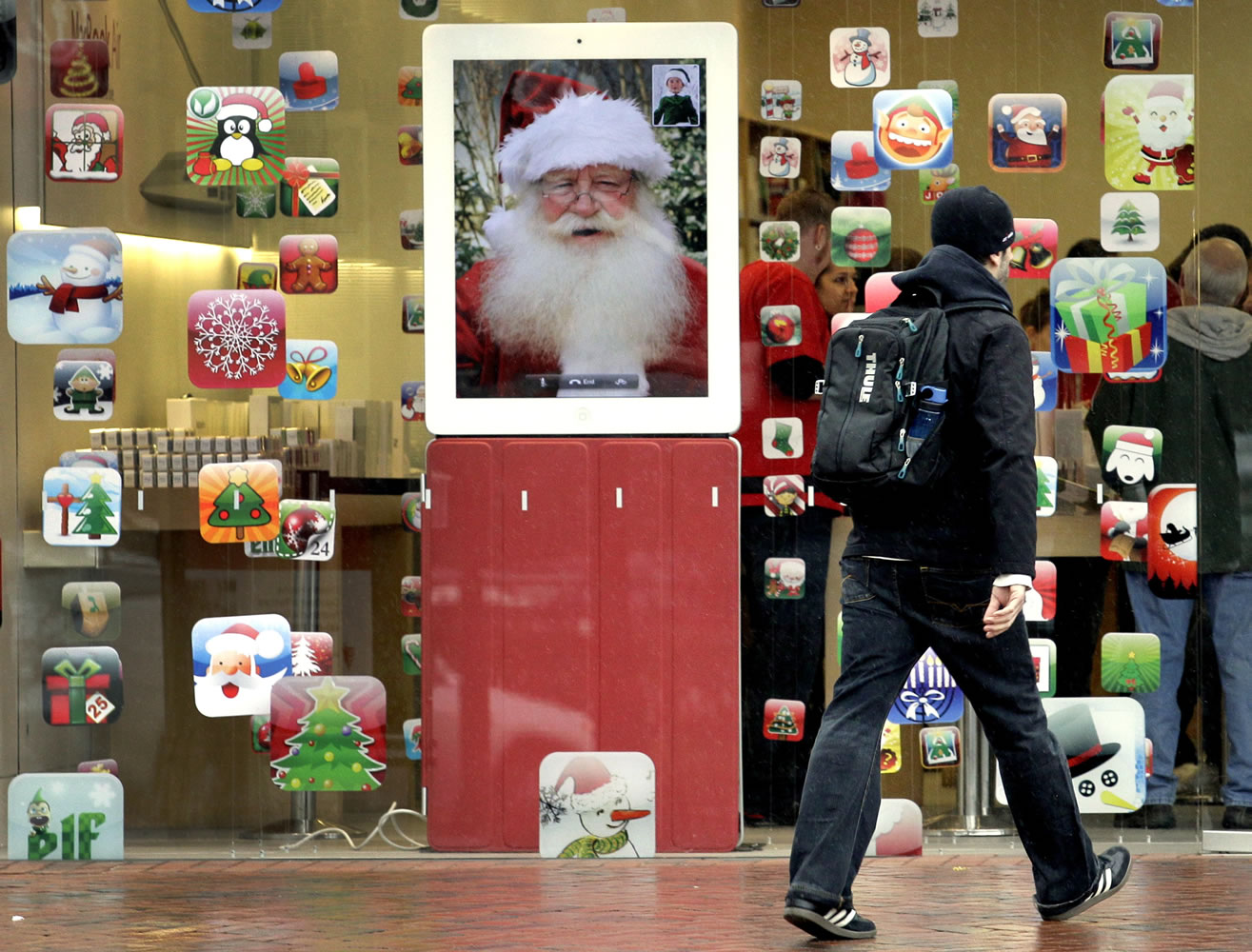 A shopper heads into the Apple store at Legacy Village shopping plaza in Lyndhurst, Ohio.