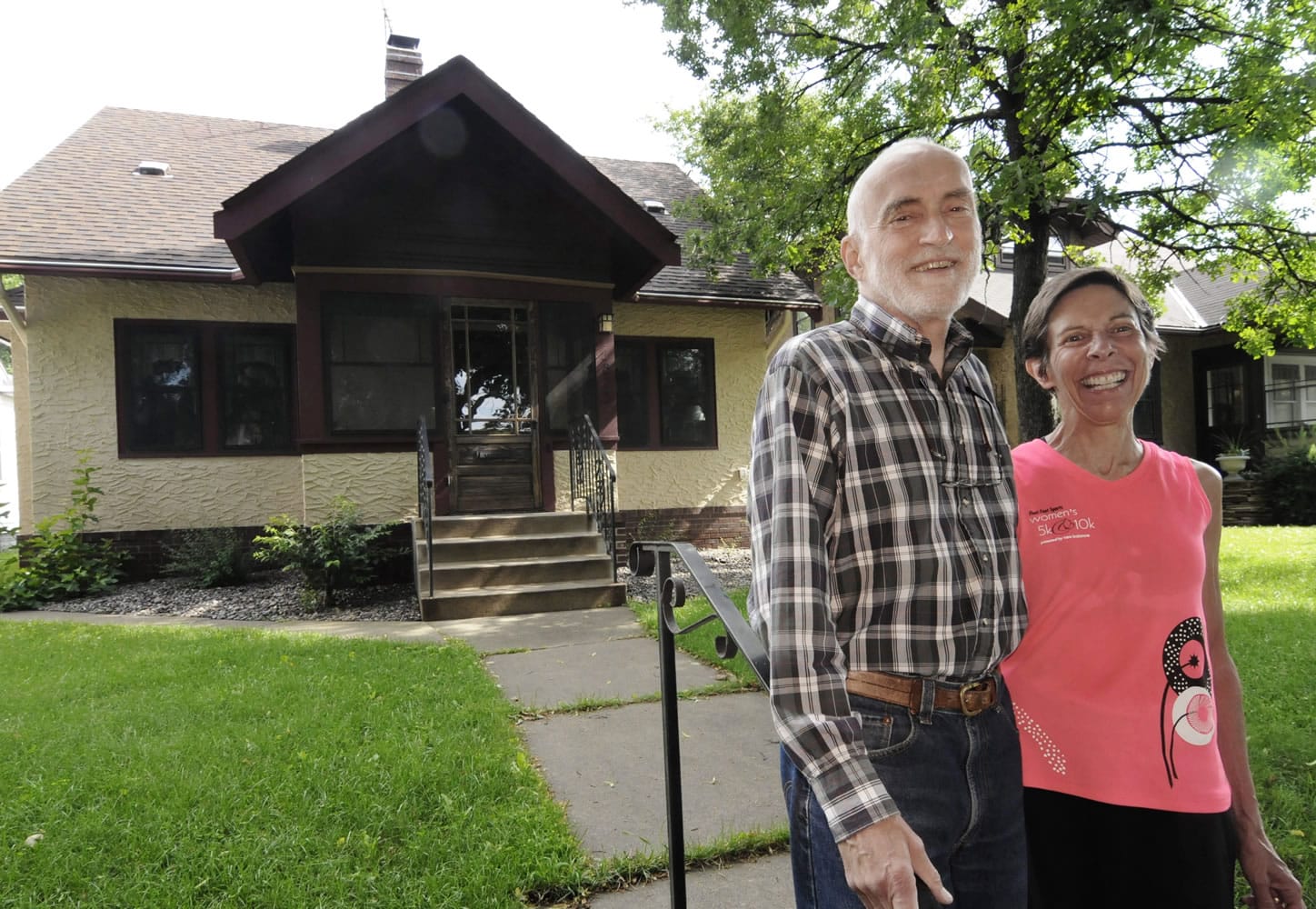 Julian Sellers and his wife Barbara stand  in front of their St. Paul, Minn., bungalow.