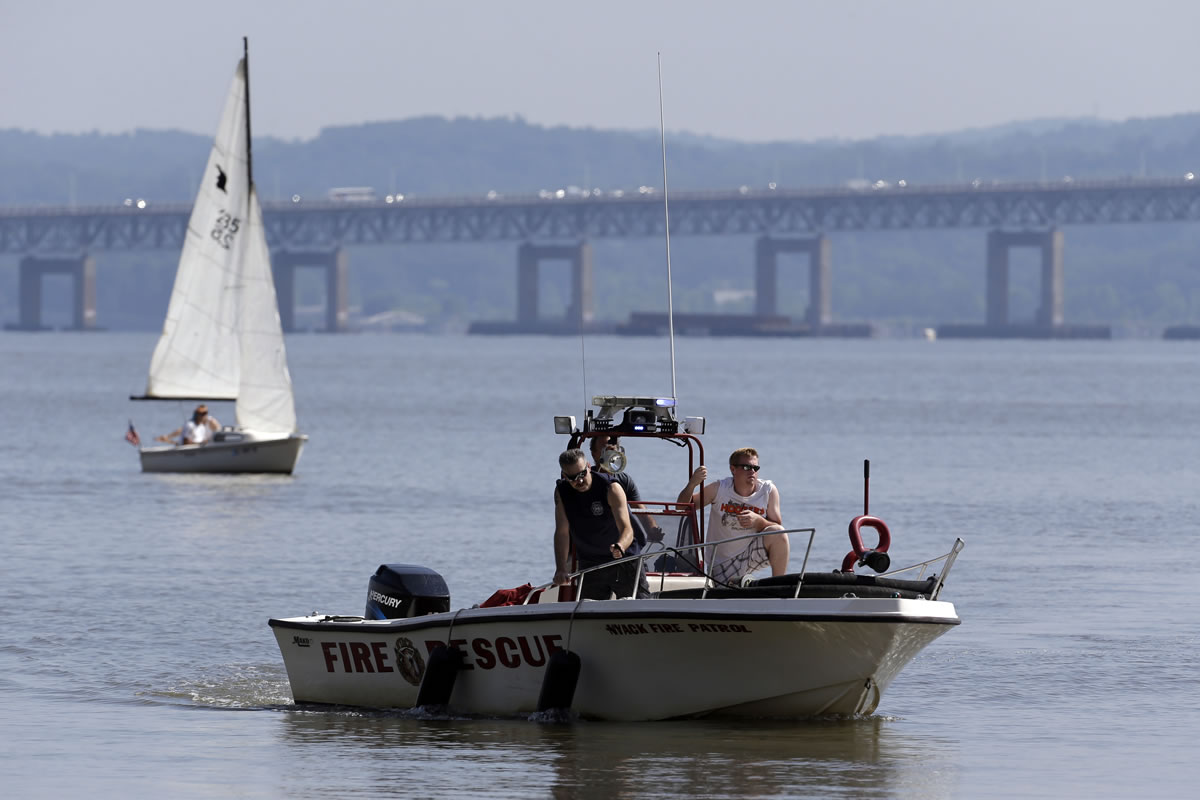 Rescue workers on a boat search the Hudson River south of the Tappan Zee Bridge for two people who went missing following a boat crash in Piermont, N.Y. on Saturday.