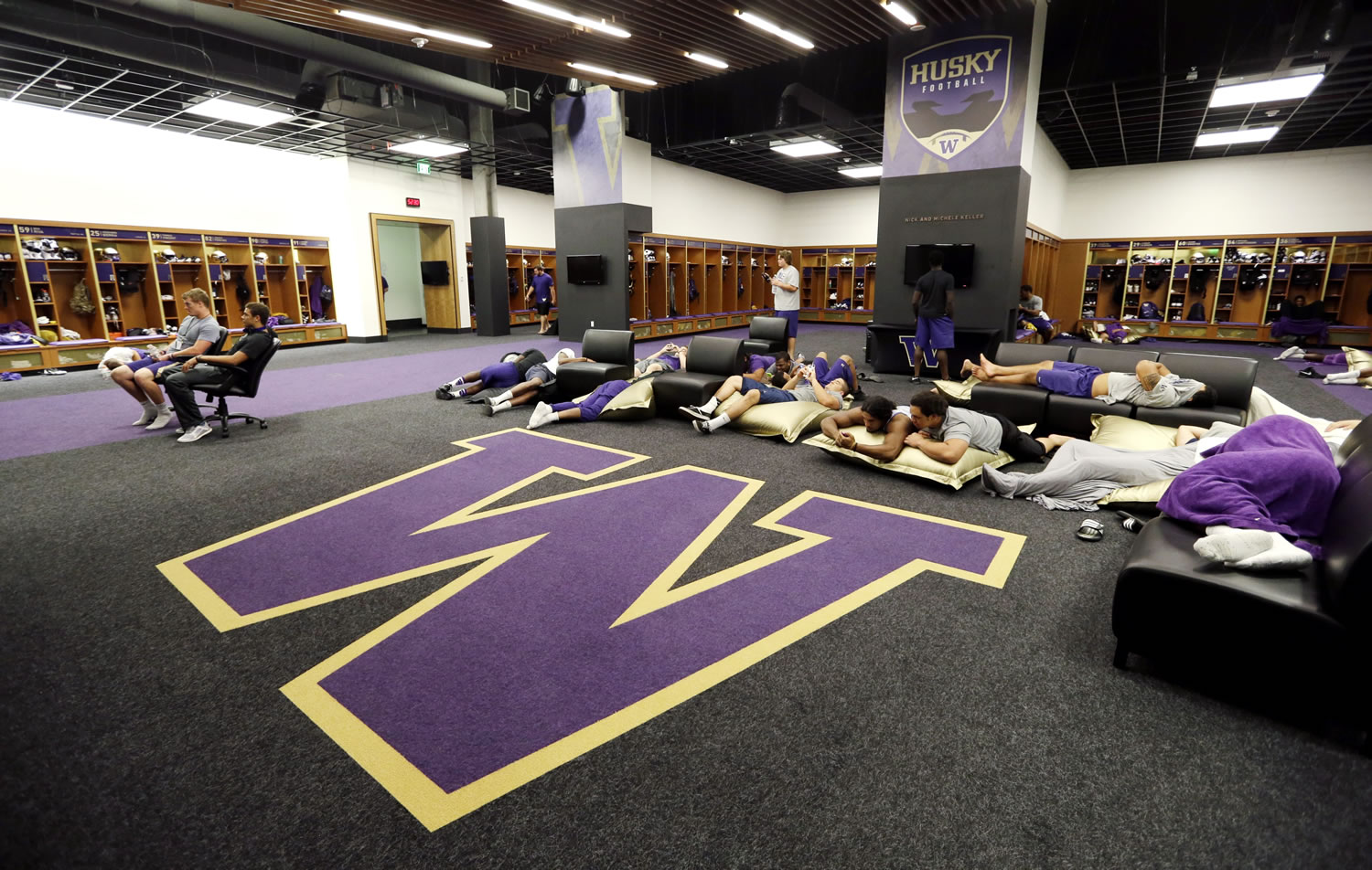 Players lounge in the home locker room at the newly renovated Husky Stadium.