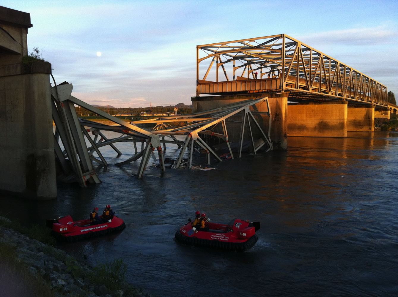 A portion of the Interstate 5 bridge is submerged after it collapsed into the Skagit River dumping vehicles and people into the water in Mount Vernon on Thursday.