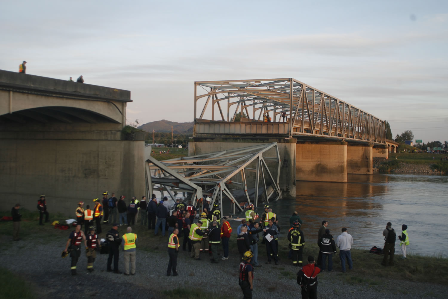 A portion of the Interstate-5 bridge is submerged after it collapsed into the Skagit river dumping vehicles and people into the water in Mount Vernon on Thursday.