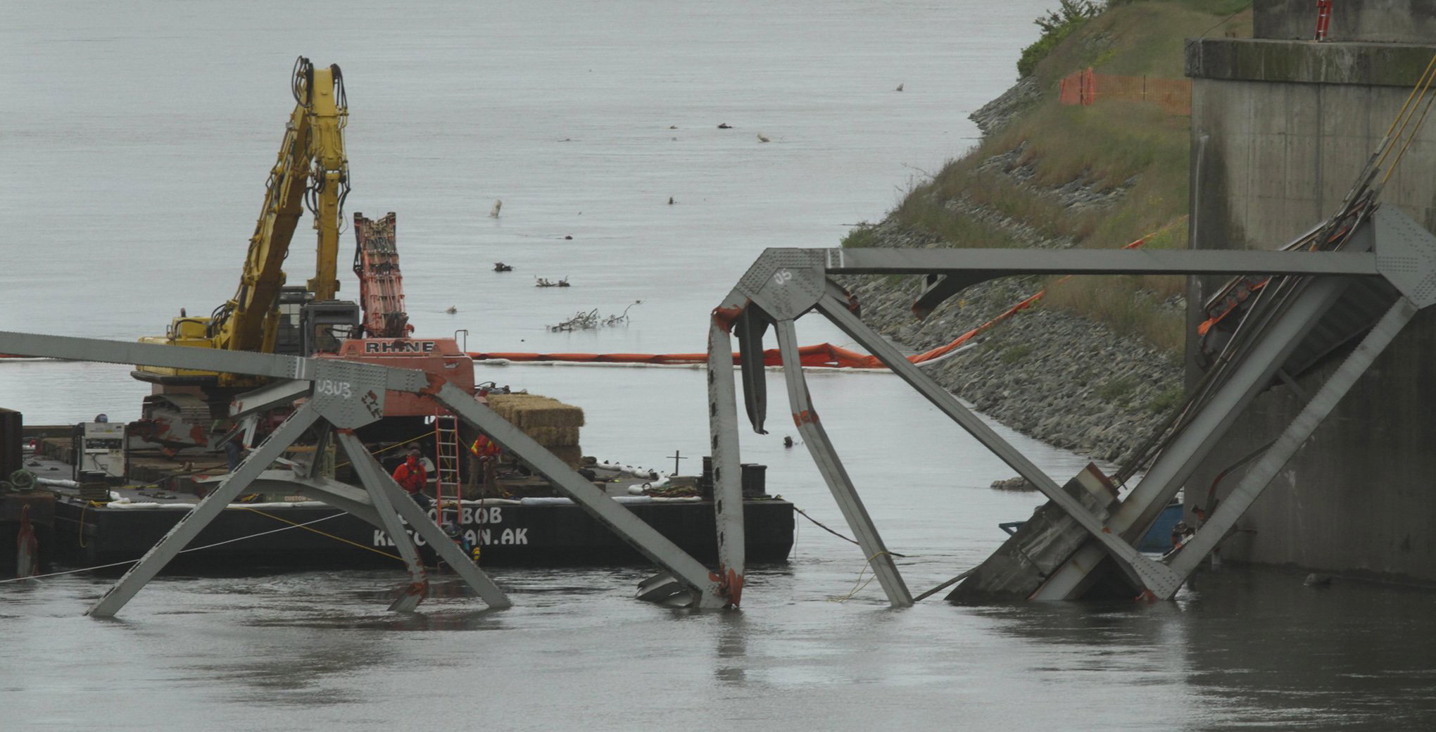 Steel beams are removed from the water in Mount Vernon on Tuesday, following the collapse of a section of the I-5 bridge over the Skagit River last week.