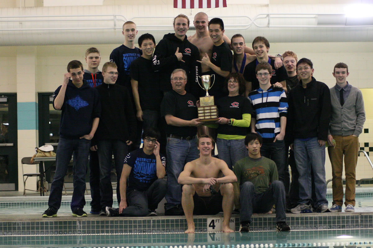 The Camas High School boys swimmers and their coaches celebrate winning the 4A district championship meet Thursday, at Propstra Pool. The Papermakers racked up 459 points.
