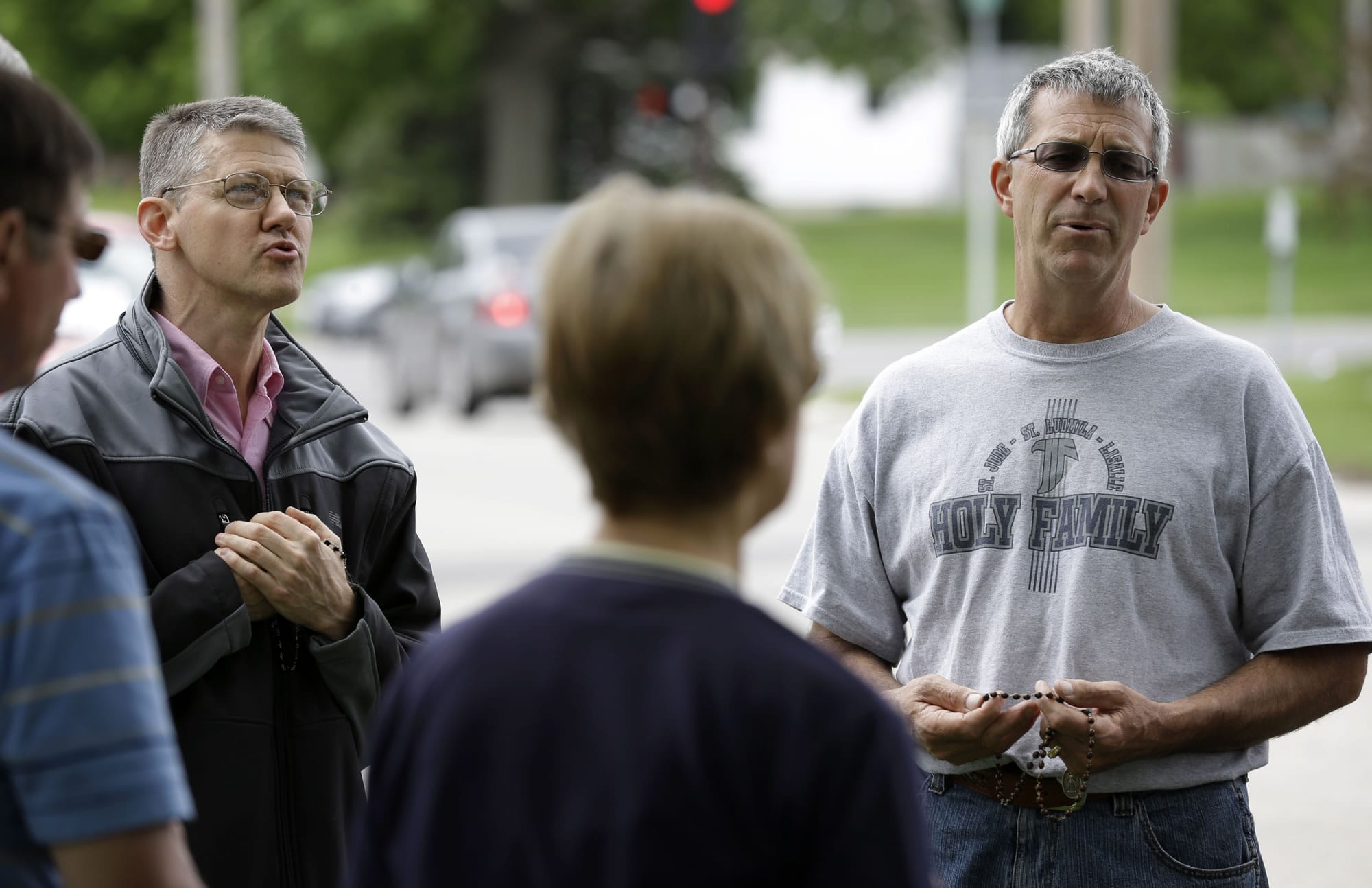 Coalition for Life of Iowa members Marty Lammers, left, and Ron Digmann pray the Rosary outside the Planned Parenthood clinic on Tuesday in Cedar Rapids, Iowa.