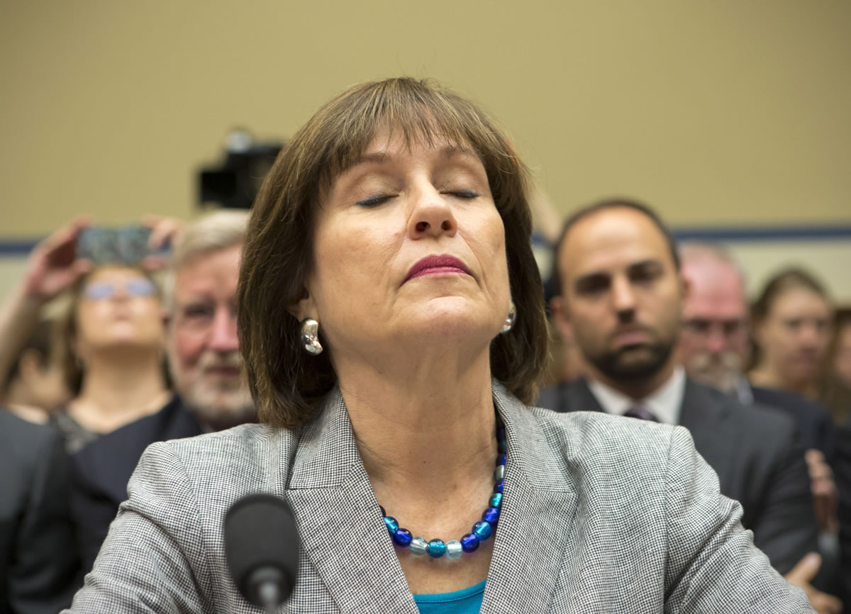 Lois Lerner, head of the IRS unit that decides whether to grant tax-exempt status to groups, listens on Capitol Hill in Washington on Wednesday.