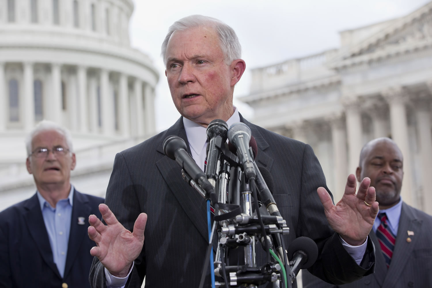 Sen. Jeff Sessions, R-Ala., center, speaks at a news conference hosted by the Tea Party Patriots to oppose the Senate immigration reform bill, Thursda on Capitol Hill in Washington. Behind him are Hans Marsen, left, an immigrant from England, and Niger Innis with TheTeaParty.Net.