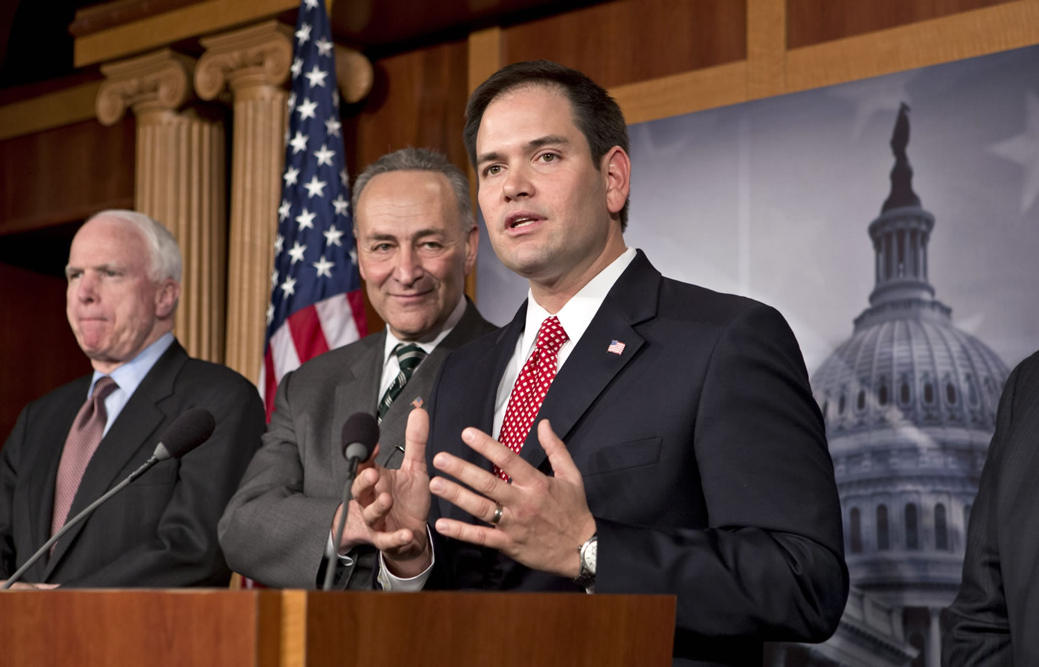 Sen. Marco Rubio, R-Fla., center, takes a reporter's question as a bipartisan group of leading senators announce that they have reached agreement on the principles of sweeping legislation to rewrite the nation's immigration laws during a news conference at the Capitol in Washington on Monday. From left are Sen. John McCain, R-Ariz., and Sen. Charles Schumer, D-N.Y.